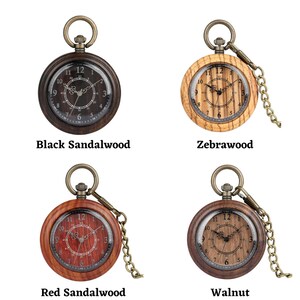 May include: Four pocket watches with different wood finishes: black sandalwood, zebrawood, red sandalwood, and walnut. Each watch has a round, silver face with black Roman numeral markings and a chain.