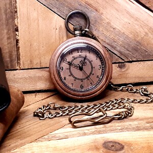 May include: A vintage-style pocket watch with a brown leather case and a chain. The watch face has Roman numerals and a second hand.