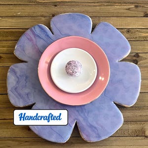 Handcrafted wall decor: lavender/ periwinkle wood flower base, glazed plates, ceramic knob. One of a kind. Ready to hang. 12" diameter.