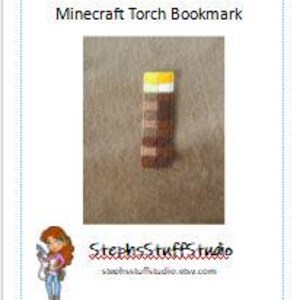 May include: A brown and orange Minecraft torch bookmark. The torch is made of felt and has a yellow flame.