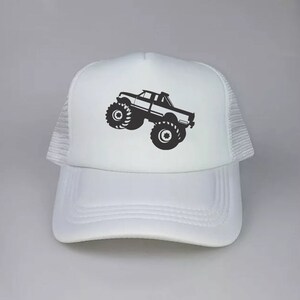 May include: White trucker hat with a black silhouette of a monster truck on the front.