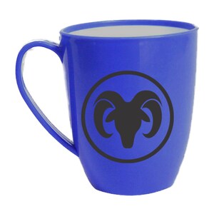 May include: Blue ceramic mug with a black ram silhouette inside a circle. The mug has a white interior and a white rim.