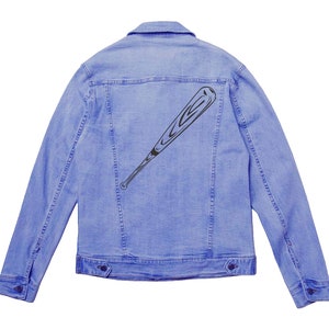 May include: A light blue denim jacket with a black baseball bat graphic on the back.