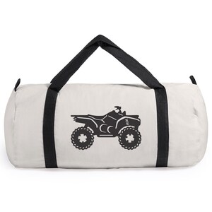 May include: White canvas duffel bag with black straps and a black silhouette of an ATV on the front.