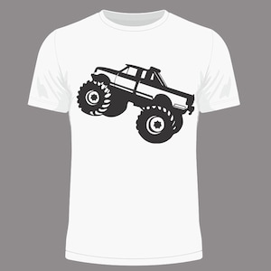 May include: A white t-shirt featuring a black silhouette of a monster truck on the front.