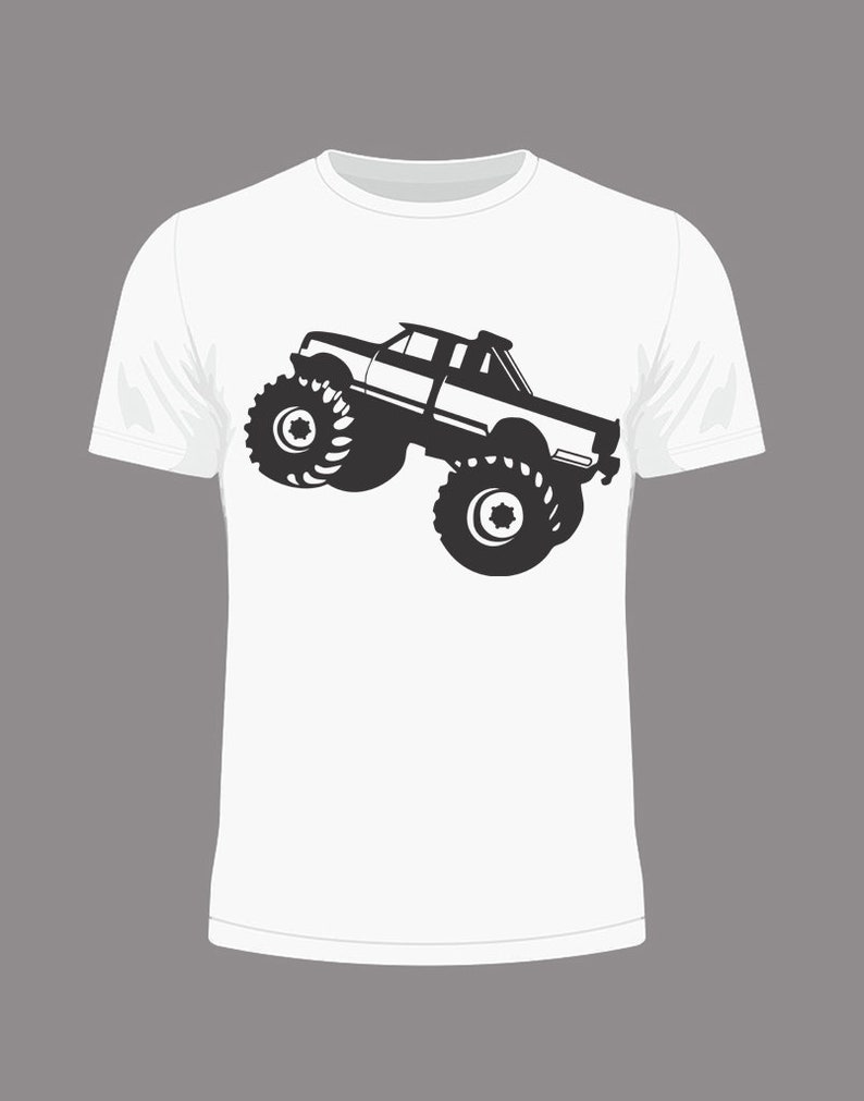 May include: A white t-shirt featuring a black silhouette of a monster truck on the front.