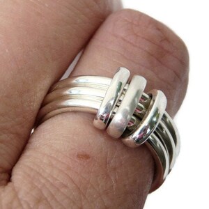 32mm sterling silver fidget rings with silver and 9ct gold charms. More charms are available in a variety of finishes, matt, black patina, polished. Perfect for playing with and charms slide easily around all stacked rings.