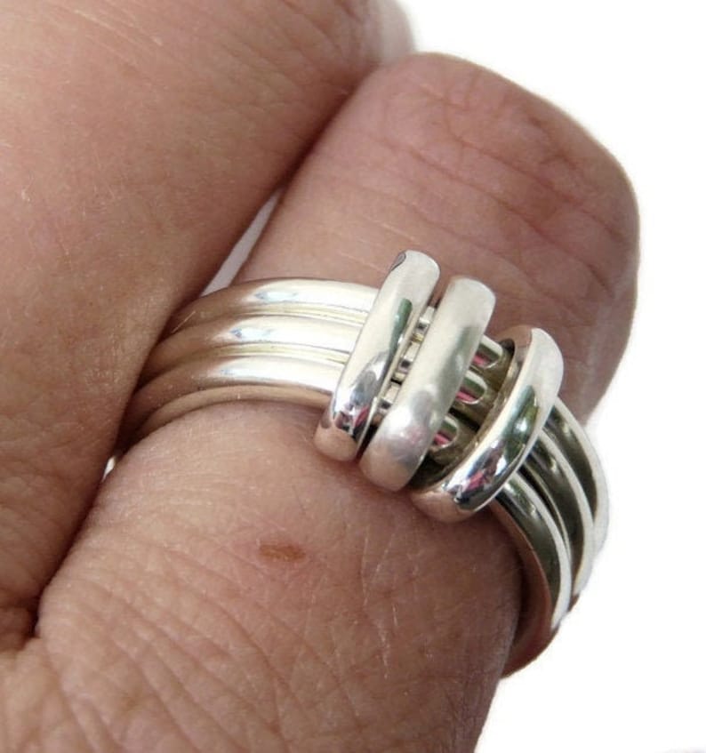 32mm sterling silver fidget rings with silver and 9ct gold charms. More charms are available in a variety of finishes, matt, black patina, polished. Perfect for playing with and charms slide easily around all stacked rings.