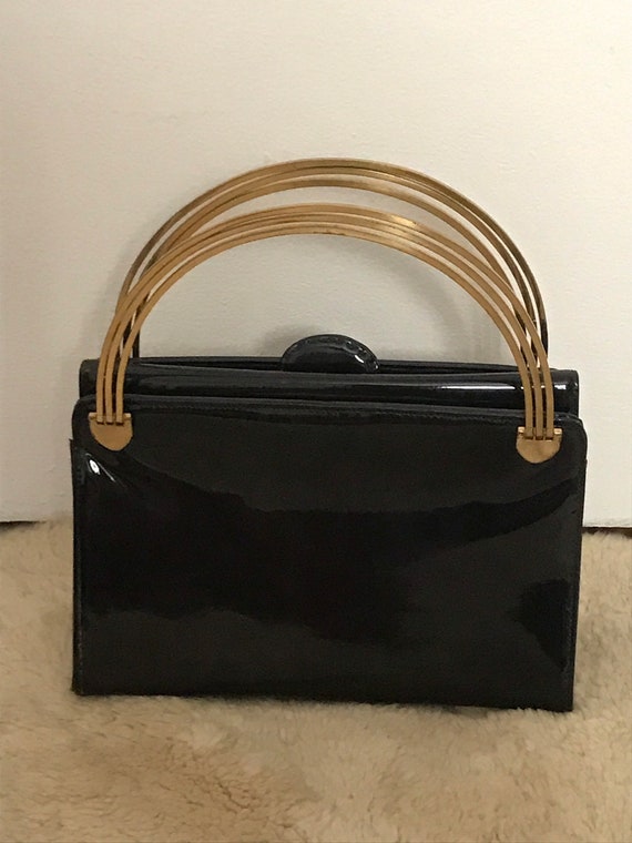 Super gorgeous gold metal handle black handbag