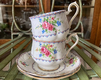 Royal Albert Petit Point Cup and Saucer Pair. Saucers 5.5  inches diameter. Produced in England 1932 to 2001.