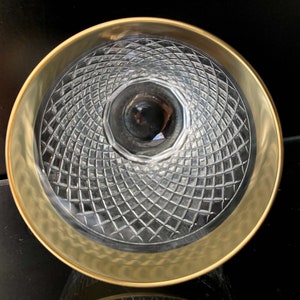 May include: A clear glass bowl with a gold rim and a diamond-shaped pattern on the bottom.