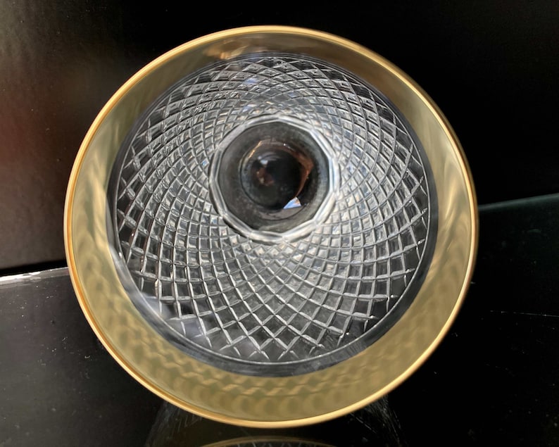 May include: A clear glass bowl with a gold rim and a diamond-shaped pattern on the bottom.