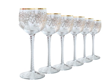May include: Set of six clear glass wine glasses with a gold rim and a silver grapevine design.