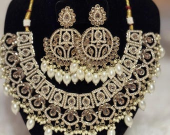Golden Stoned and off-white pearls necklace set with Tikka