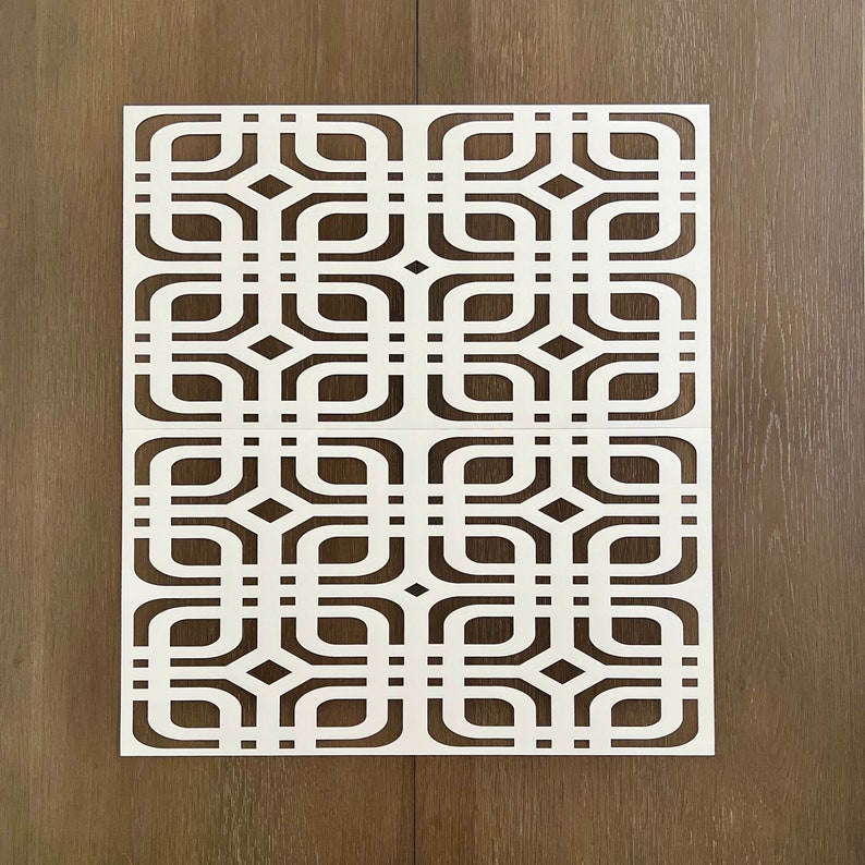 May include: White geometric stencil with a repeating pattern of squares and rounded shapes. The stencil is made of a thin, flexible material and is designed for use with paint or other mediums.