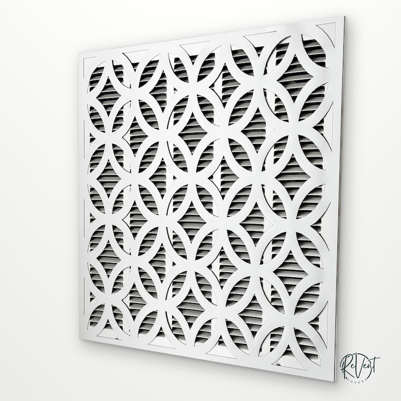 May include: A square white air vent cover featuring a repeating geometric pattern of interlocking circles. The decorative front panel is layered over a series of horizontal slats. The text ReVent Covers is printed in the bottom right corner.