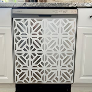 May include: A stainless steel dishwasher with a white geometric pattern on the front. The dishwasher is labelled "FRIGIDAIRE" and has a control panel with buttons for "Cycles", "Options", "Temperature", "Custom", "Delay", "Start", and "Cancel".
