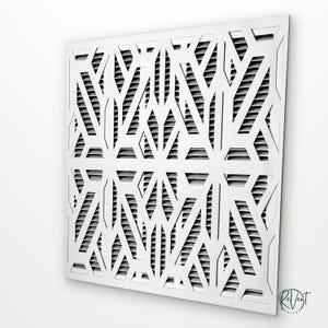 May include: A square white air vent cover featuring a geometric cutout pattern with sharp angles and intersecting lines. The design consists of a repeating symmetrical motif layered over horizontal slats, with the ReVent Covers logo in the corner.