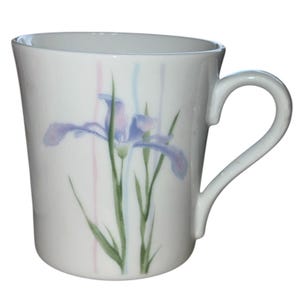 May include: A set of three ceramic mugs with a speckled, matte finish. The mugs are in shades of cream, light gray, and dark gray. Each mug has a simple, minimalist design and a rounded handle.