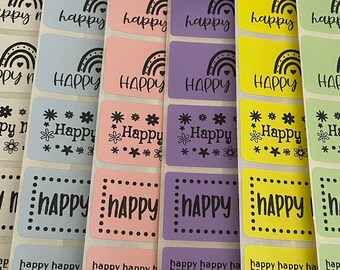 May include: Six rows of colorful rectangular stickers with the text "Happy Mail" on the green stickers. The stickers have different designs, including rainbows, flowers, and polka dots.