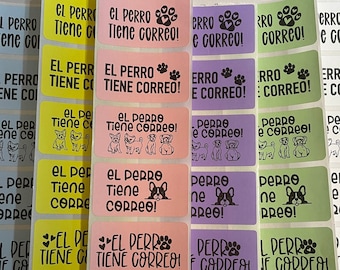 May include: A set of colorful stickers with the text "El perro tiene correo!" and "El perro tiene correo!" in Spanish. The stickers feature paw prints and a dog illustration.