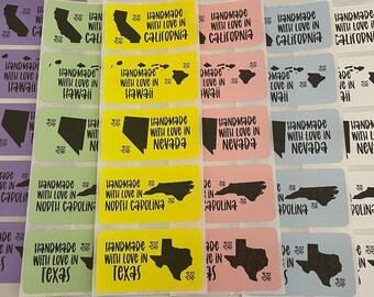May include: Assortment of colorful stickers with state outlines and the text "Handmade with love in [state name]" printed on them. The states include California, Hawaii, Nevada, North Carolina, and Texas.