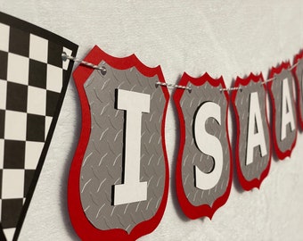 May include: A red and gray banner with the name "Isaac" spelled out in white letters. Each letter is on a separate shield-shaped piece of the banner.