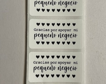 May include: Four white rectangular stickers with black text and hearts. The text on the stickers reads "Gracias por apoyar mi pequeño negocio".
