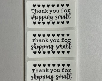 May include: Five white rectangular stickers with black hearts and the text "Thank you for shopping small".