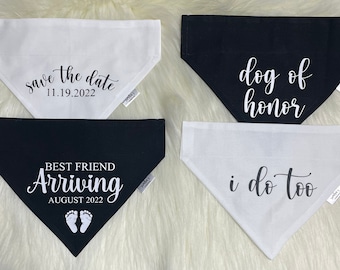 May include: Four dog bandanas with different wedding-themed text. The bandanas are white and black with black text. The text reads "save the date 11.19.2022", "best friend arriving august 2022", "dog of honor", and "i do too".