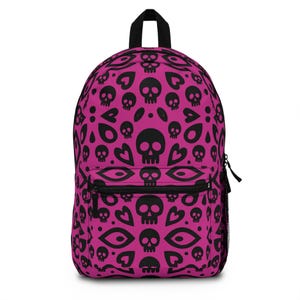 May include: A magenta backpack featuring a black skull pattern. The design incorporates skulls, hearts, and eye shapes. The backpack has a black zip, a top handle, and adjustable straps.