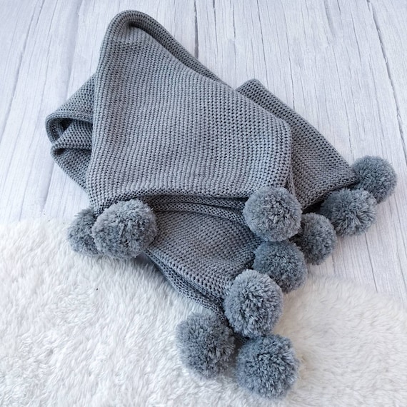 Grey knitted throw with pom poms sale