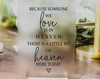 May include: A frosted acrylic sign with the text "Because someone we love is in heaven there is a little bit of heaven here today".