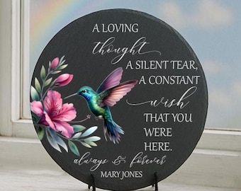 May include: Round black slate plaque with a hummingbird and floral design. The plaque features the text "A Loving Thought, A Silent Tear, A Constant Wish, That You Were Here, Always & Forever, Mary Jones."