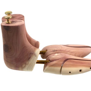 May include: A pair of cedar shoe trees with brass adjusters. The shoe trees are designed to help maintain the shape of shoes and absorb moisture.