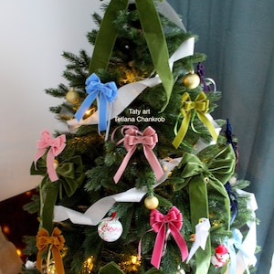 May include: A green Christmas tree decorated with green, blue, pink, and gold velvet bows, white ribbon, and ornaments. The tree is topped with a large green velvet bow. The text "Taty art Tetiana Chankrob" is visible on the tree.