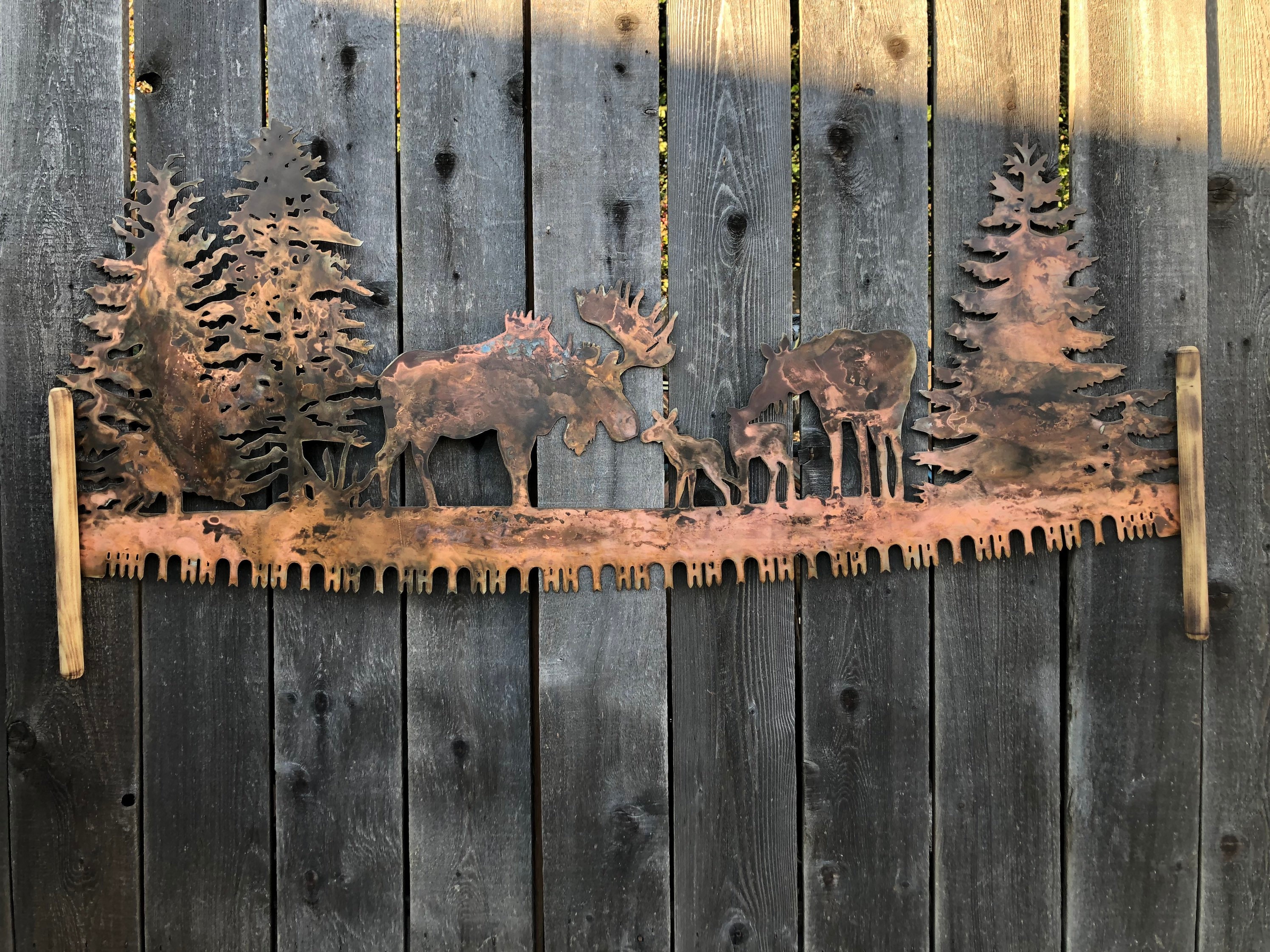 Moose in trees crosscut saw metal wall art