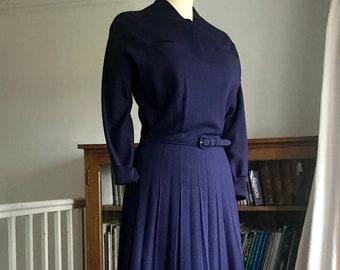 1940s jersey dress in navy wool with sunray pleated skirt, dolman sleeves and jetted breast pockets