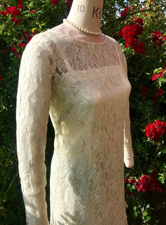 1960s lace dress with scalloped pleating at hem