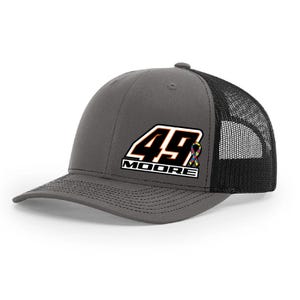 May include: Gray trucker hat with a black mesh back. The front features the number "49" in orange and white, with the name "MOORE" below, and a colorful ribbon.
