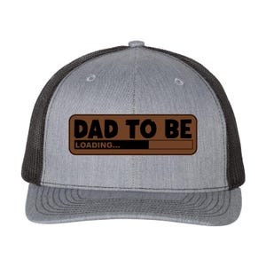 May include: Gray trucker hat with a black mesh back. The front of the hat features a brown rectangle with the words "DAD TO BE" above "LOADING..." and a loading bar graphic.
