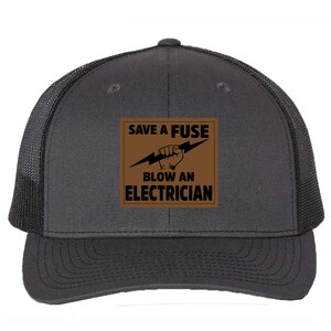 May include: A black and brown trucker hat with a brown patch that says "Save a Fuse Blow an Electrician" with a lightning bolt and a fist.