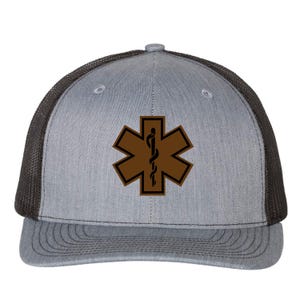 May include: A grey and black trucker hat featuring a brown Star of Life emblem on the front panel. The cap has a structured grey front, a flat brim, and a black mesh back with a button on top. The medical symbol is centered on the front.
