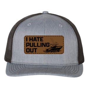 May include: A grey and black trucker hat featuring a rectangular brown patch on the front. The patch displays the black text I HATE PULLING OUT alongside a graphic illustration of a motorboat on the water, with visible stitching around the edges.