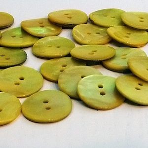 May include: A collection of 20 yellow and green shell buttons, each with two holes.