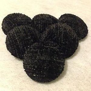 May include: Six black, round, textured buttons with a shiny finish.