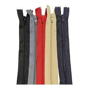 May include: Five zipper closures in different colours: black, grey, red, beige, and navy blue. The zippers are all the same size and style.