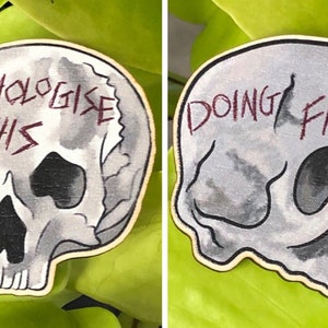 Angrily Invalid Wooden Skull Pins - “Doing Fine” and “Pathologise this”