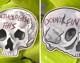 Angrily Invalid Wooden Skull Pins - “Doing Fine” and “Pathologise this”