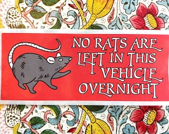 May include: A red sticker with a white border and white text that reads "NO RATS ARE LEFT IN THIS VEHICLE OVERNIGHT". A cartoon rat is illustrated in the upper left corner of the sticker.